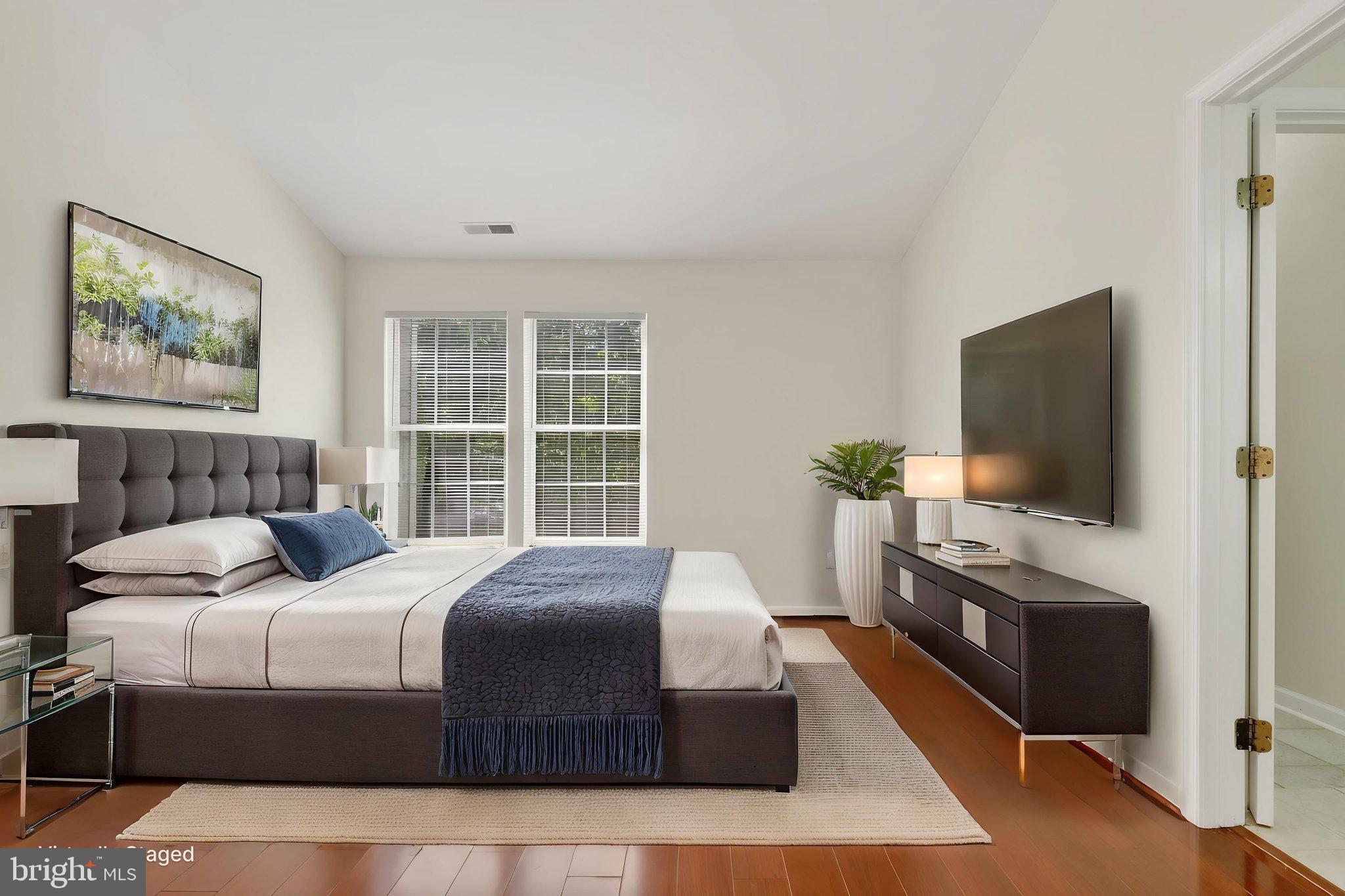 8612 Fire Rock Road Laurel, MD 20724 - Photo 25 of 57 a bedroom with a large bed and a flat screen tv