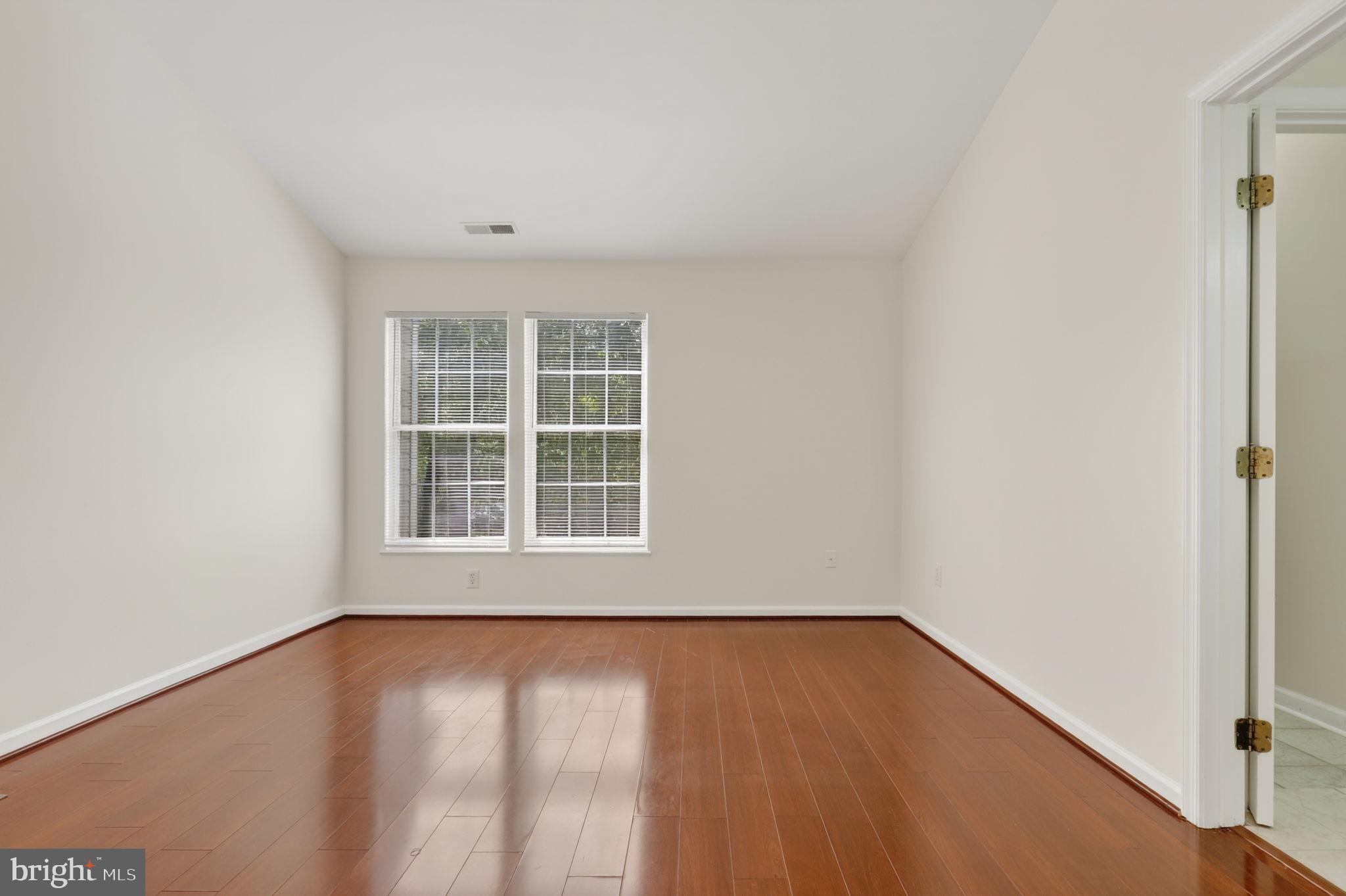 8612 Fire Rock Road Laurel, MD 20724 - Photo 26 of 57 an empty room with wooden floor and windows