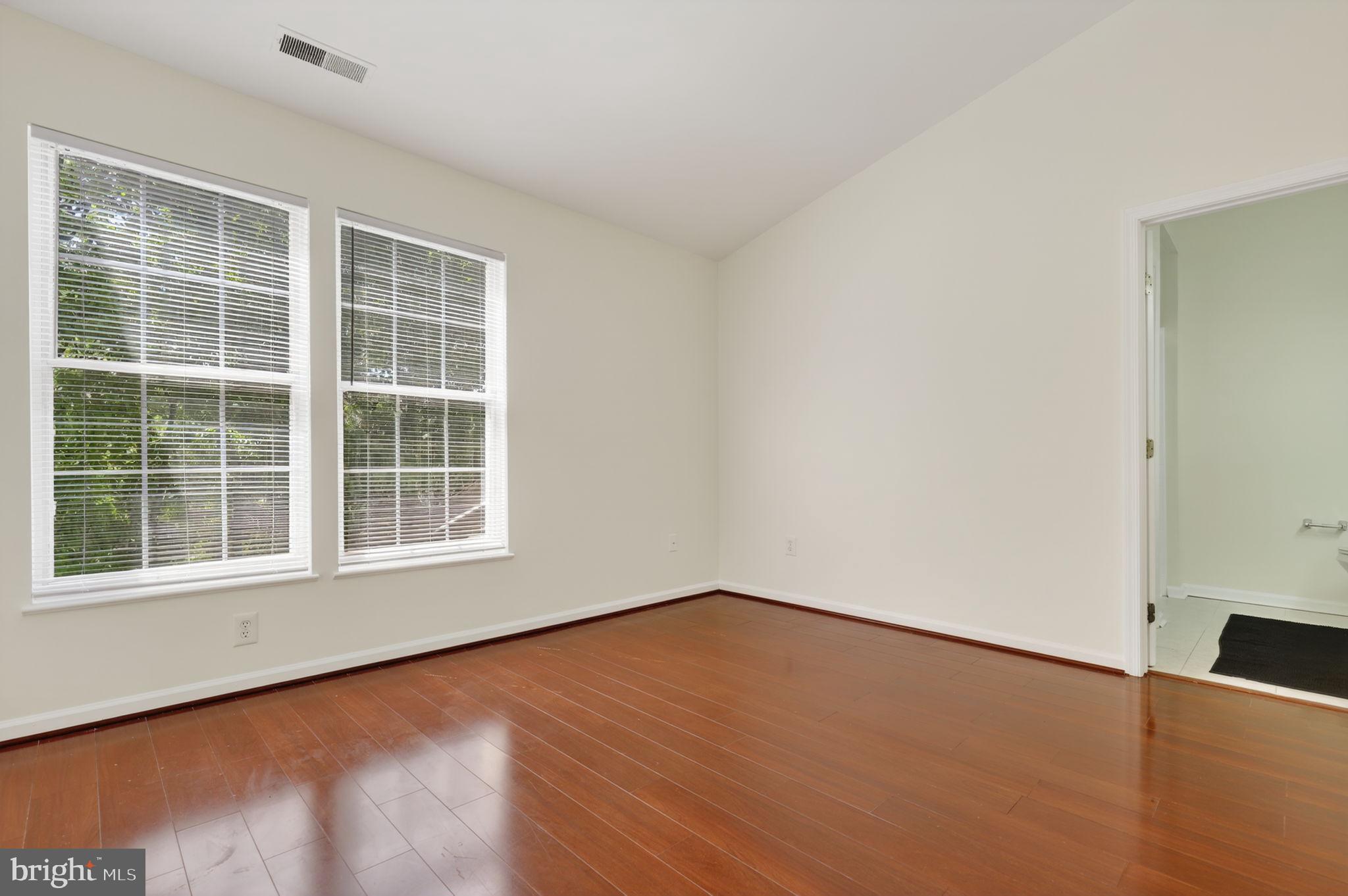 8612 Fire Rock Road Laurel, MD 20724 - Photo 27 of 57 an empty room with wooden floor and windows