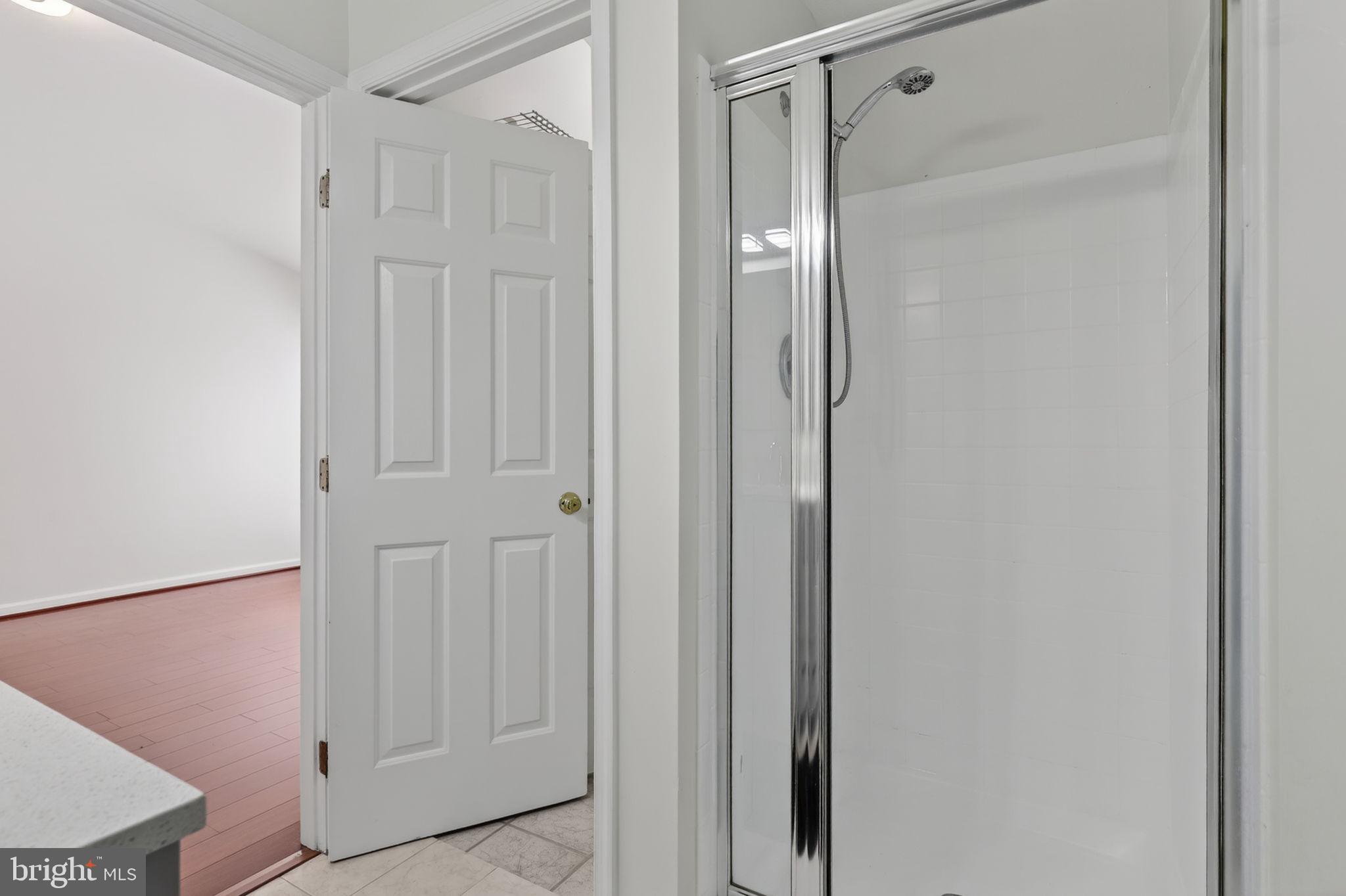 8612 Fire Rock Road Laurel, MD 20724 - Photo 29 of 57 a bathroom with a shower and a glass door