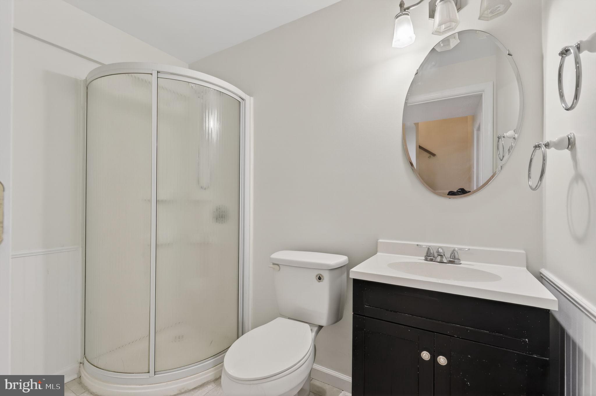 8612 Fire Rock Road Laurel, MD 20724 - Photo 38 of 57 a bathroom with a toilet sink vanity and mirror