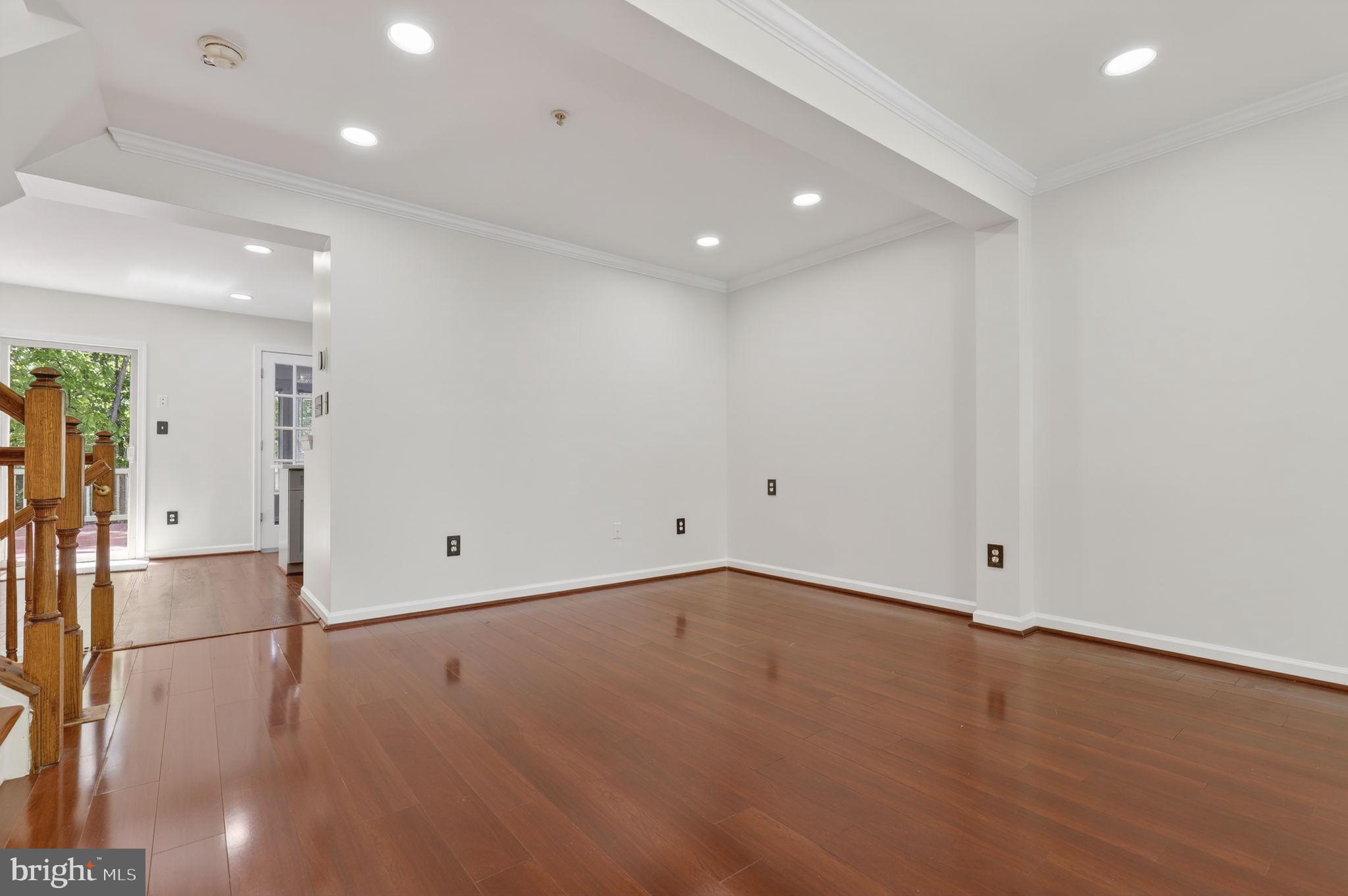 8612 Fire Rock Road Laurel, MD 20724 - Photo 4 of 57 an empty room with wooden floor and appliances