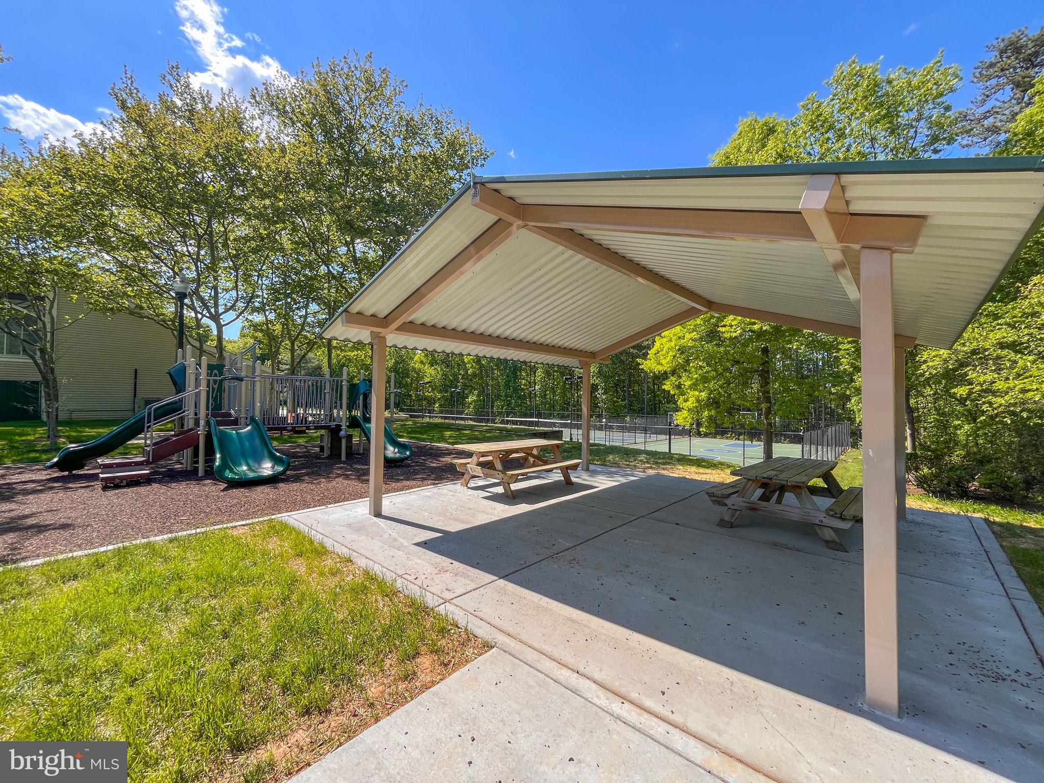 8612 Fire Rock Road Laurel, MD 20724 - Photo 54 of 57 a view of a patio with table and chairs under an umbrella