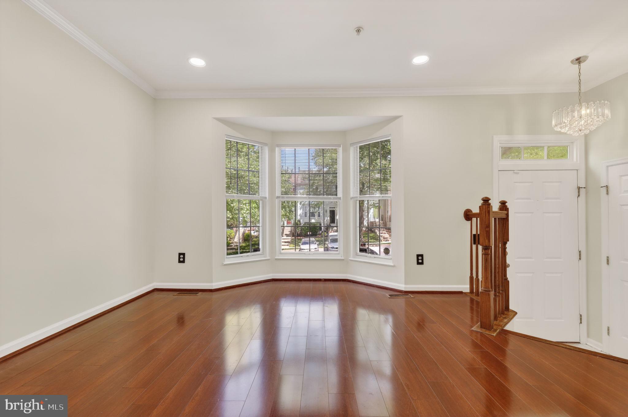 8612 Fire Rock Road Laurel, MD 20724 - Photo 7 of 57 an empty room with wooden floor and windows