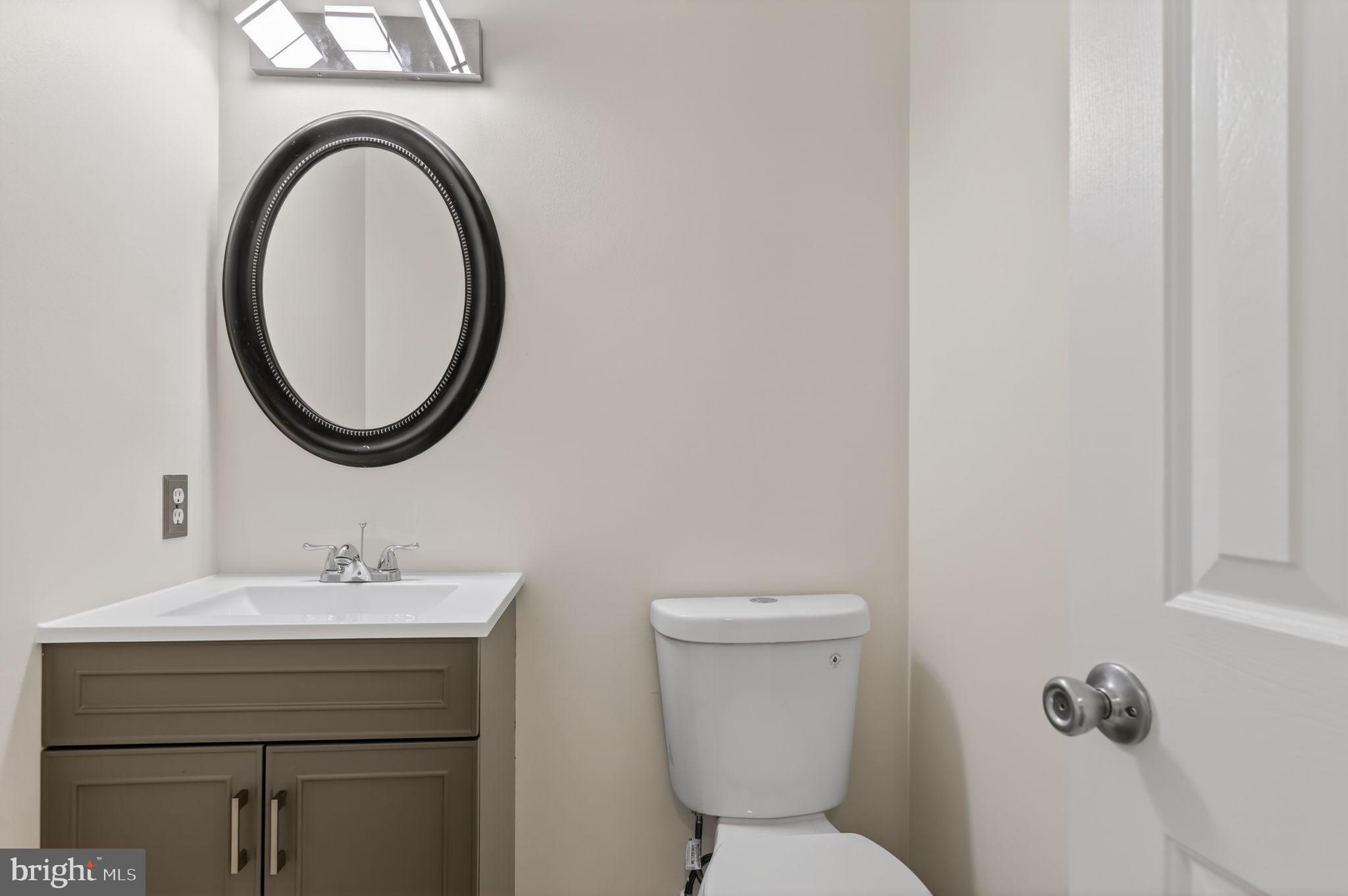 8612 Fire Rock Road Laurel, MD 20724 - Photo 9 of 57 a bathroom with a toilet sink and mirror