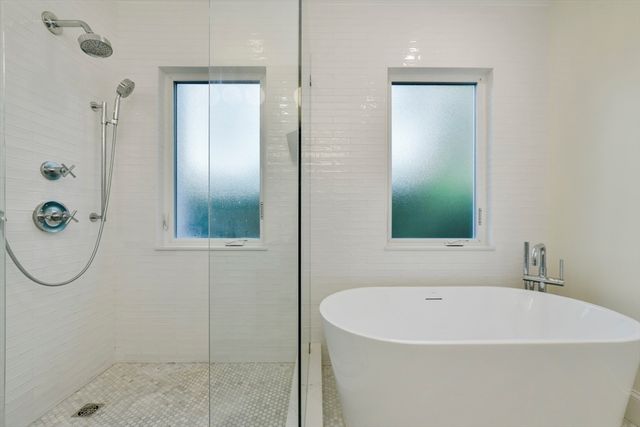 a bathroom with a bathtub and a shower