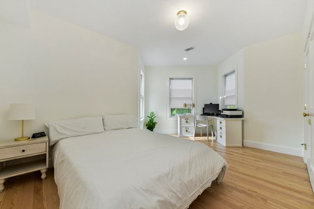 a bedroom with a bed and a view of kitchen