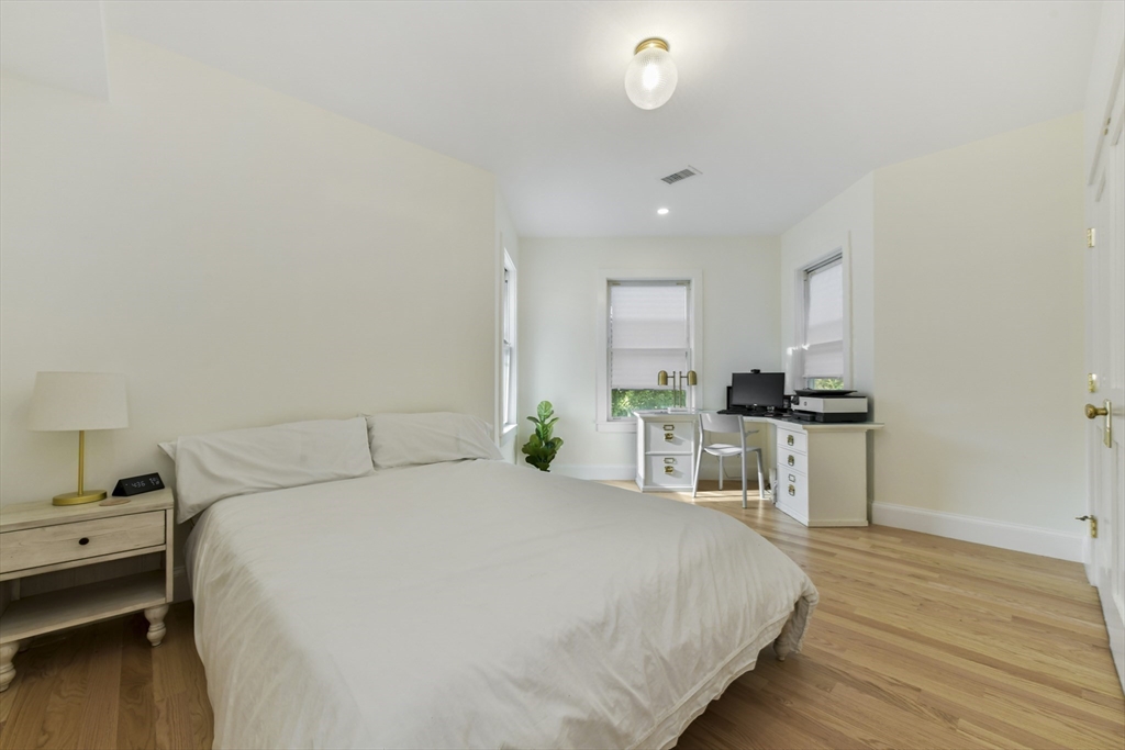 26 Bartlett Avenue Arlington, MA 02476 - Photo 12 of 27 a bedroom with a bed and a view of kitchen