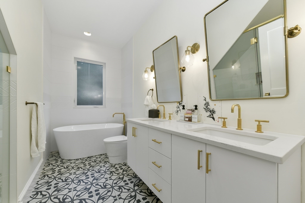 26 Bartlett Avenue Arlington, MA 02476 - Photo 13 of 27 a bathroom with a double vanity sink mirror and toilet