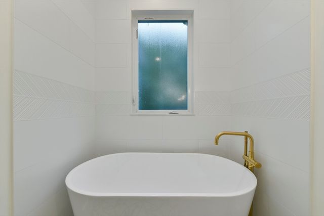 a white bath tub sitting in a bathroom