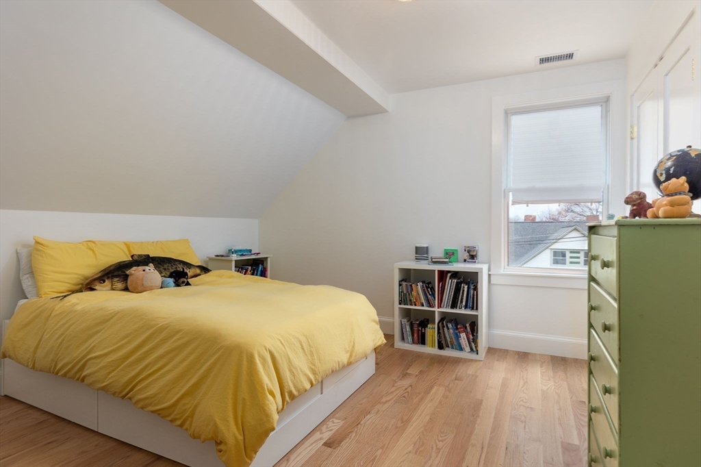 26 Bartlett Avenue Arlington, MA 02476 - Photo 20 of 27 a bedroom with a bed and a closet