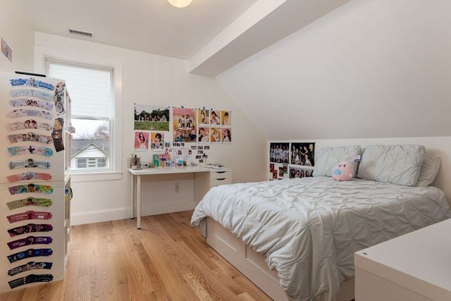 a bedroom with a bed and a dresser