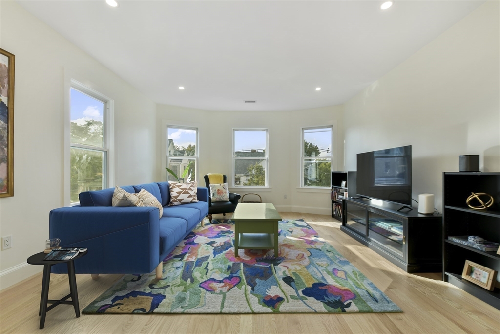26 Bartlett Avenue Arlington, MA 02476 - Photo 7 of 27 a living room with furniture and a flat screen tv