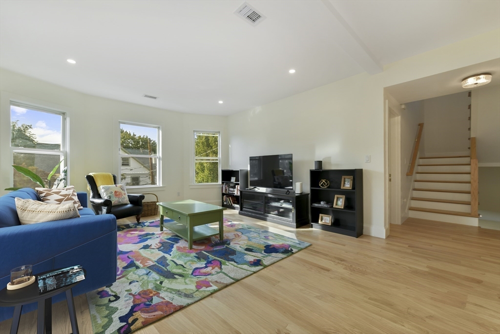 26 Bartlett Avenue Arlington, MA 02476 - Photo 8 of 27 a living room with furniture and a flat screen tv