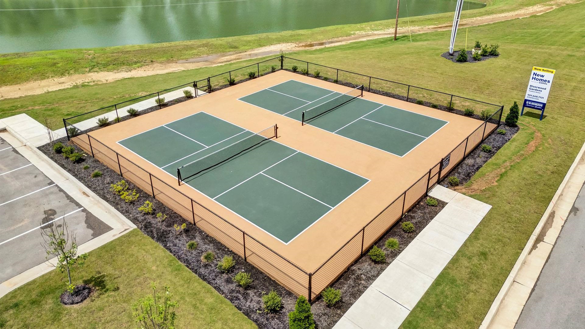 980 Mewborn Farm Road Oakland, TN 38060 - Photo 25 of 34 Two fenced pickleball courts with tan and green surfacing