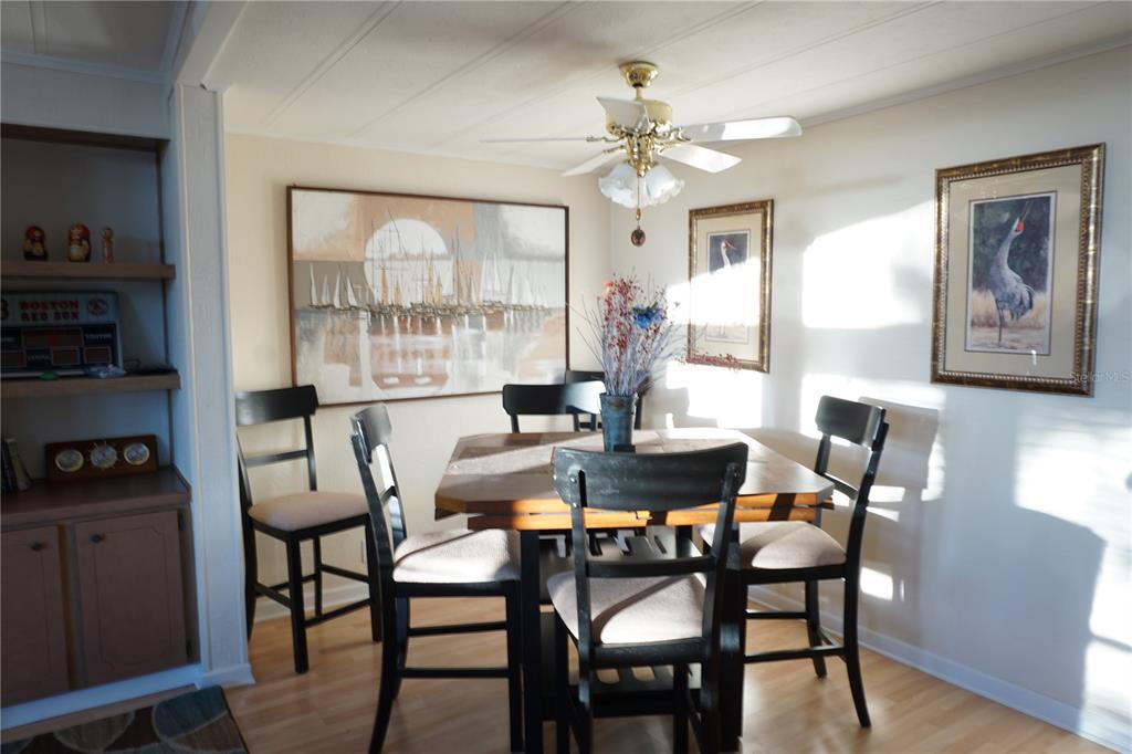 145 Rarotonga Road North Port, FL 34287 - Photo 12 of 64 a view of a dining room with furniture a chandelier and wooden floor