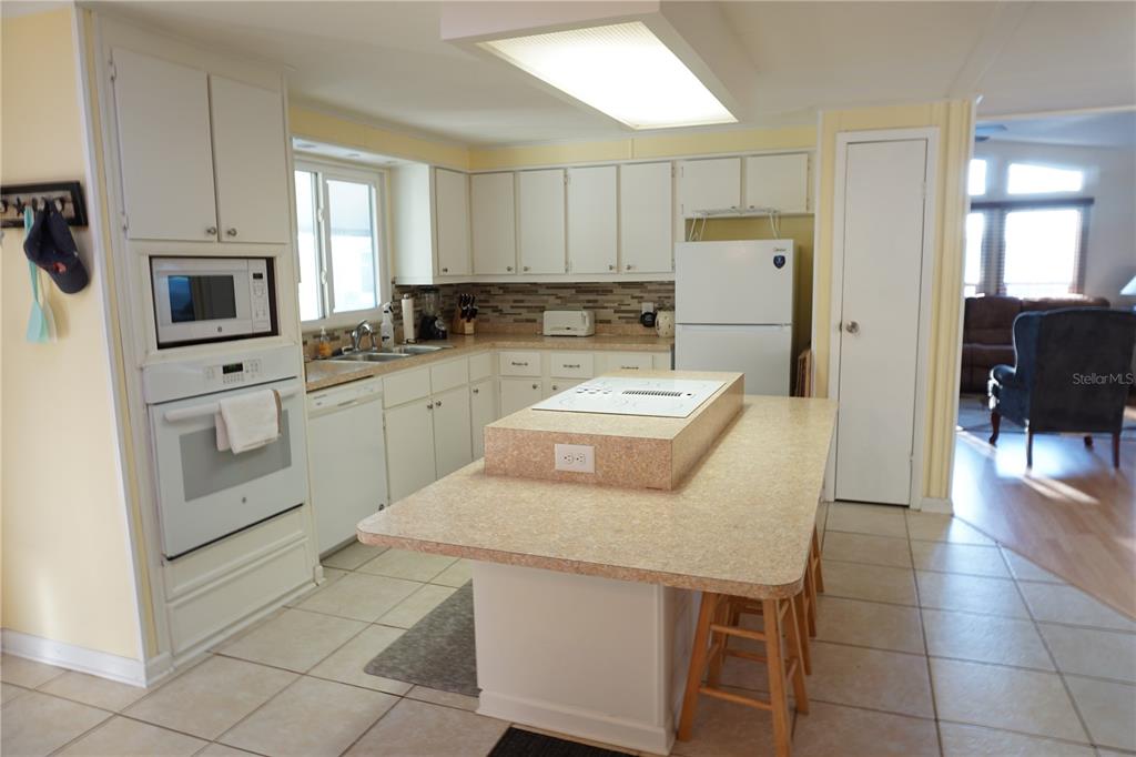 145 Rarotonga Road North Port, FL 34287 - Photo 14 of 64 a kitchen with stainless steel appliances a stove a sink a microwave a refrigerator and cabinets