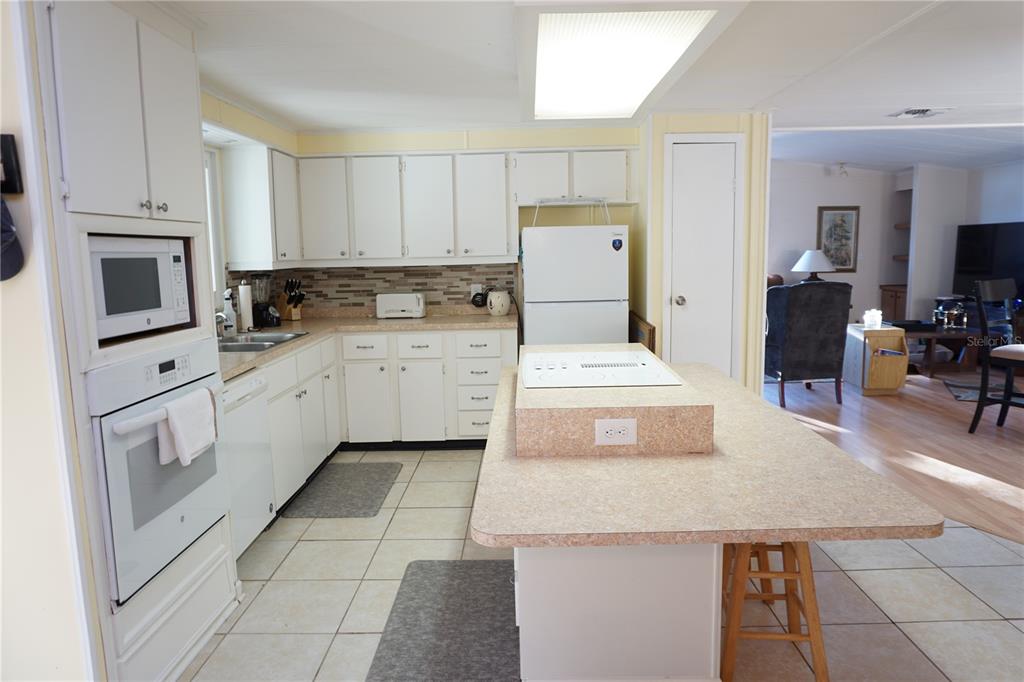 145 Rarotonga Road North Port, FL 34287 - Photo 15 of 64 a kitchen with white cabinets appliances and sink