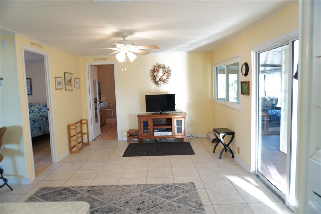 145 Rarotonga Road North Port, FL 34287 - Photo 18 of 64 a living room with furniture a flat screen tv and a fireplace