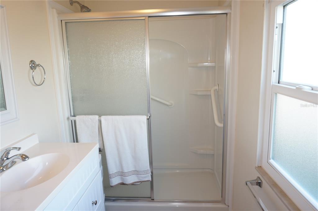 145 Rarotonga Road North Port, FL 34287 - Photo 23 of 64 a bathroom with a shower a mirror and a sink