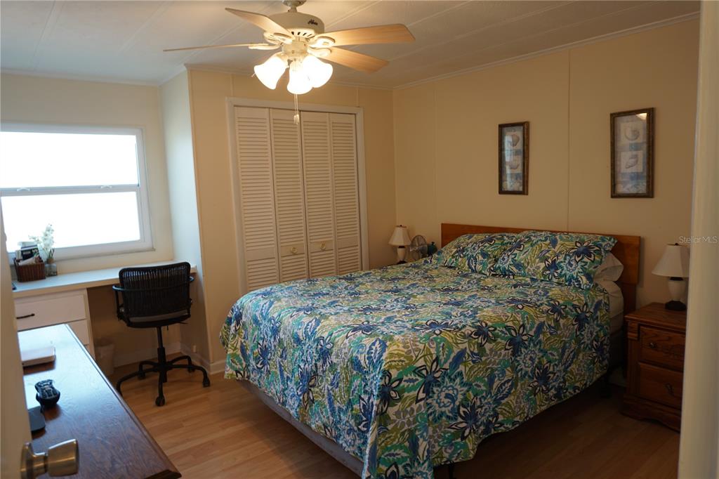 145 Rarotonga Road North Port, FL 34287 - Photo 25 of 64 a bedroom with a bed and a chandelier