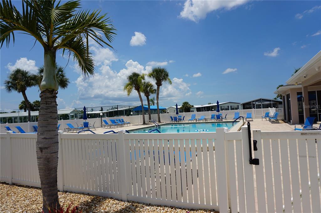 145 Rarotonga Road North Port, FL 34287 - Photo 41 of 64 a view of a house with a backyard and a palm tree