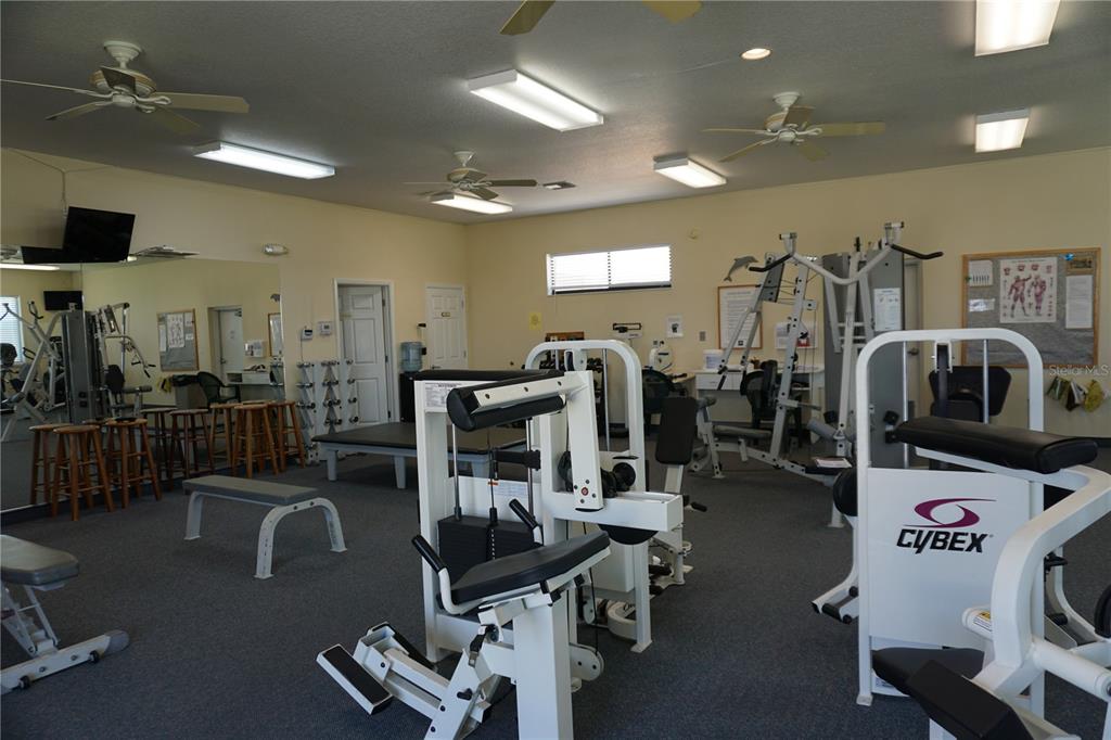 145 Rarotonga Road North Port, FL 34287 - Photo 57 of 64 a gym room with lots of gym equipment