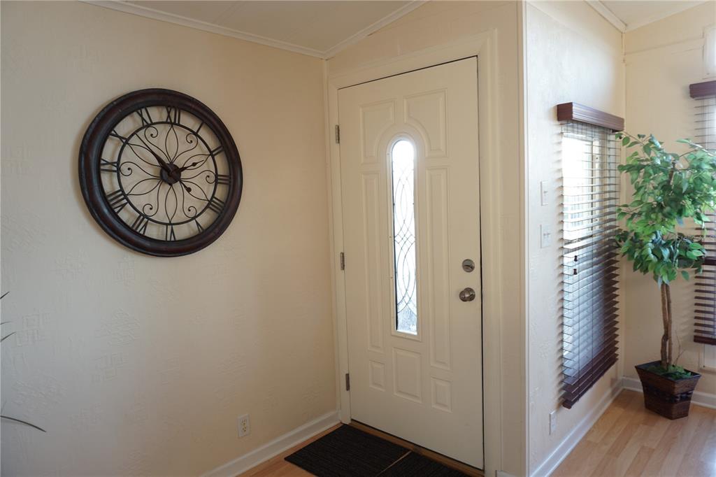 145 Rarotonga Road North Port, FL 34287 - Photo 8 of 64 a view of a room with wooden floor and a potted plant