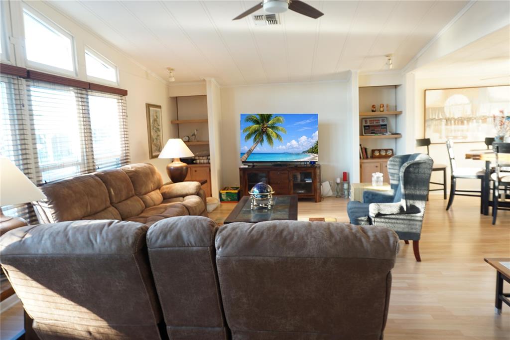 145 Rarotonga Road North Port, FL 34287 - Photo 9 of 64 a living room with furniture a fireplace and a large window
