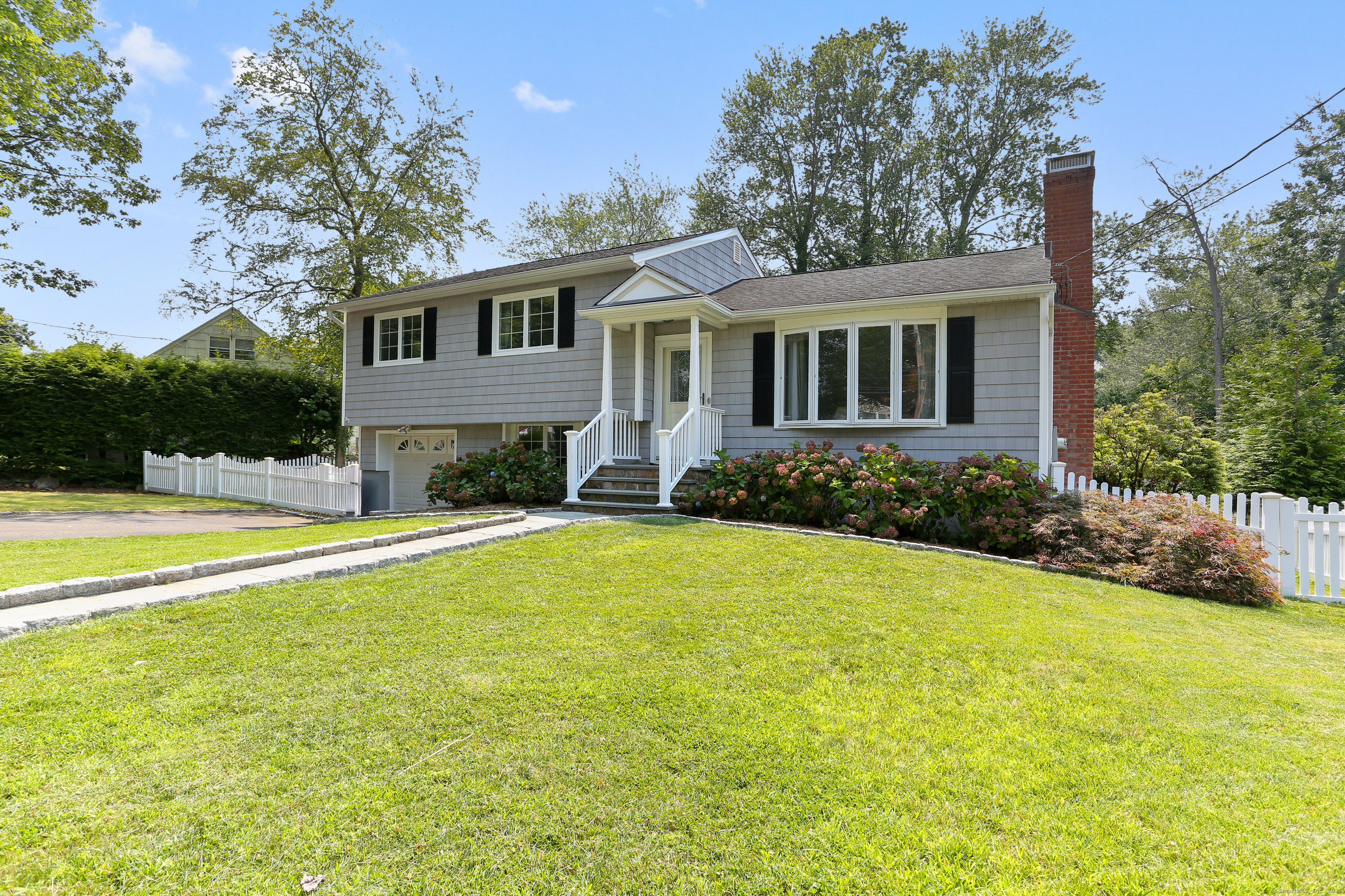 14 Windsor Place Fairfield, CT 06824 - Photo 1 of 1 a front view of house with yard and trees