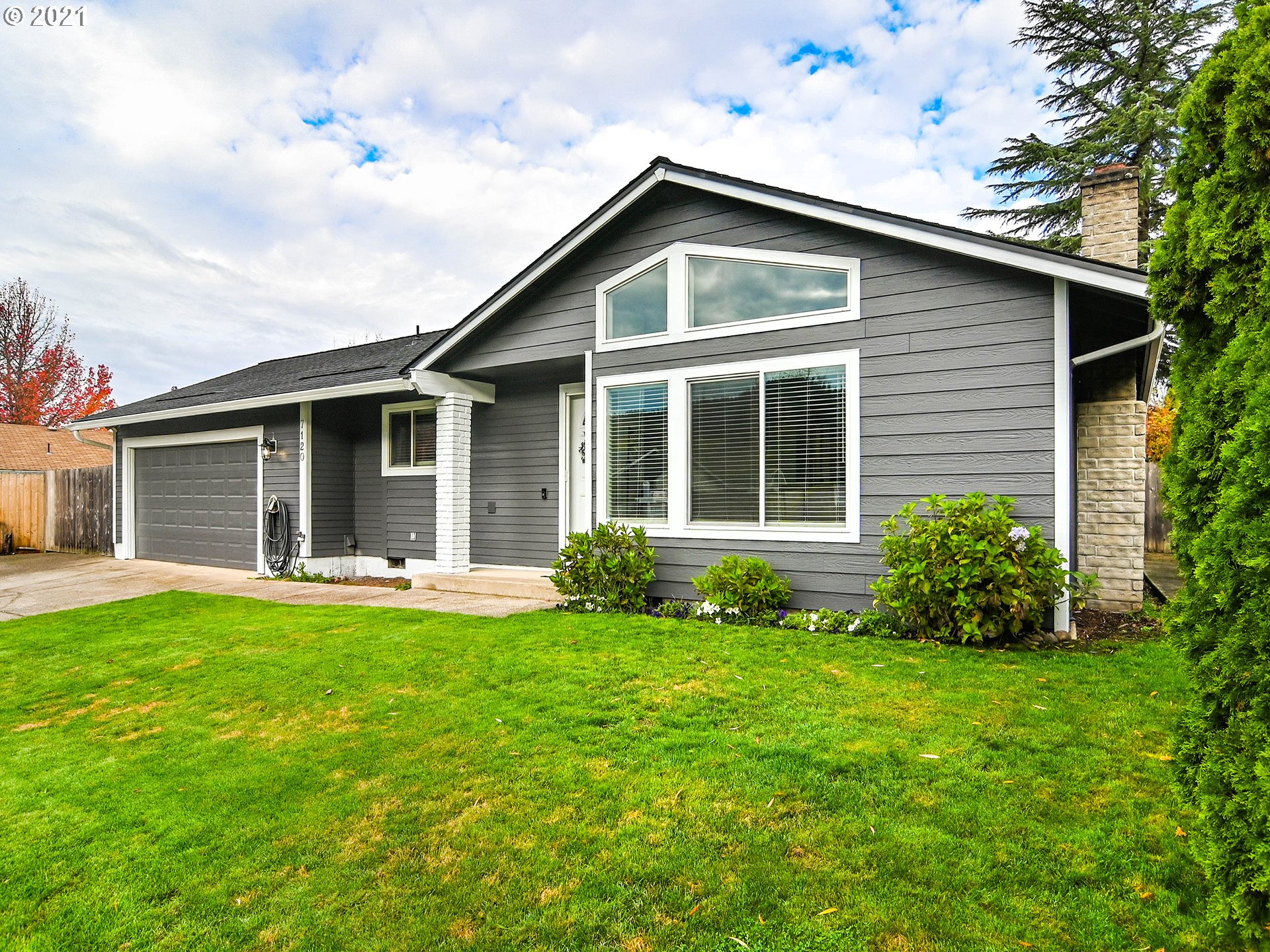 7120 B Street Springfield, OR 97478 - Photo 1 of 32 a front view of a house with a yard and porch