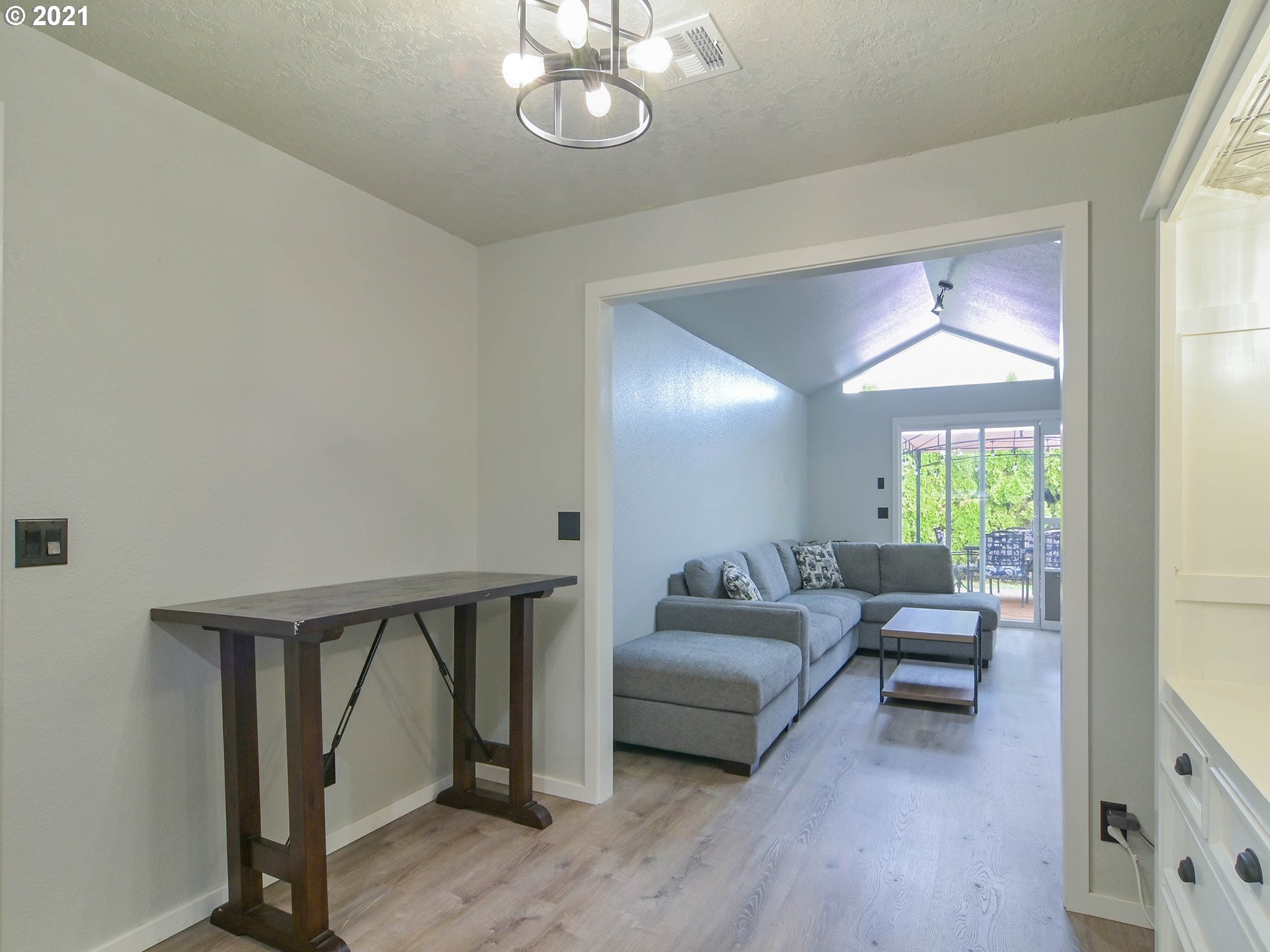 7120 B Street Springfield, OR 97478 - Photo 12 of 32 a living room with furniture and a chandelier