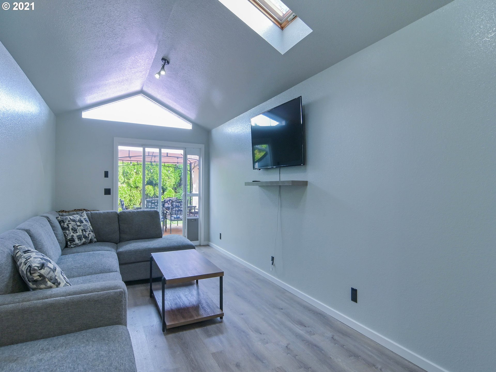 7120 B Street Springfield, OR 97478 - Photo 15 of 32 a living room with furniture and a flat screen tv