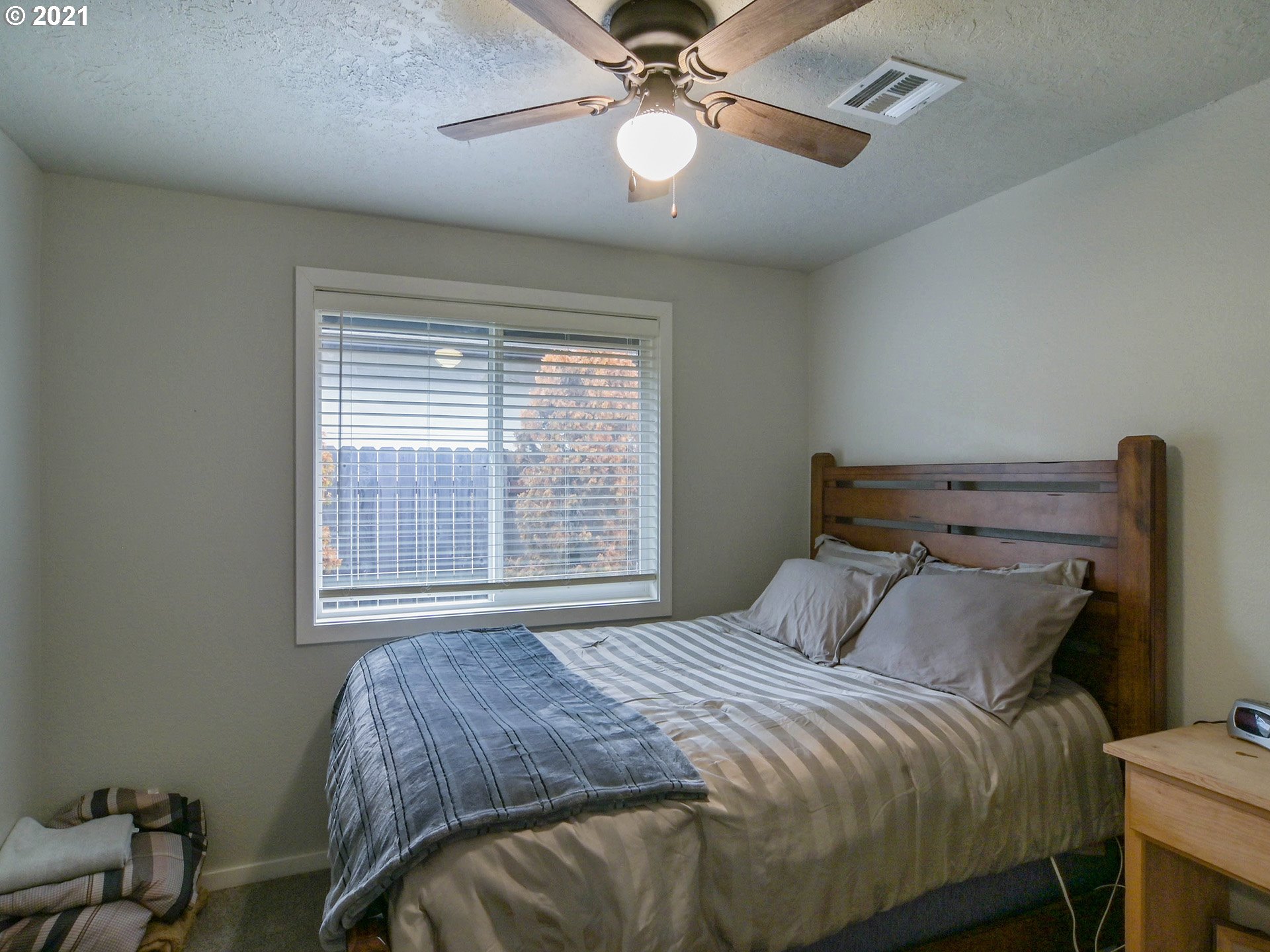 7120 B Street Springfield, OR 97478 - Photo 18 of 32 a bedroom with a bed and a chandelier