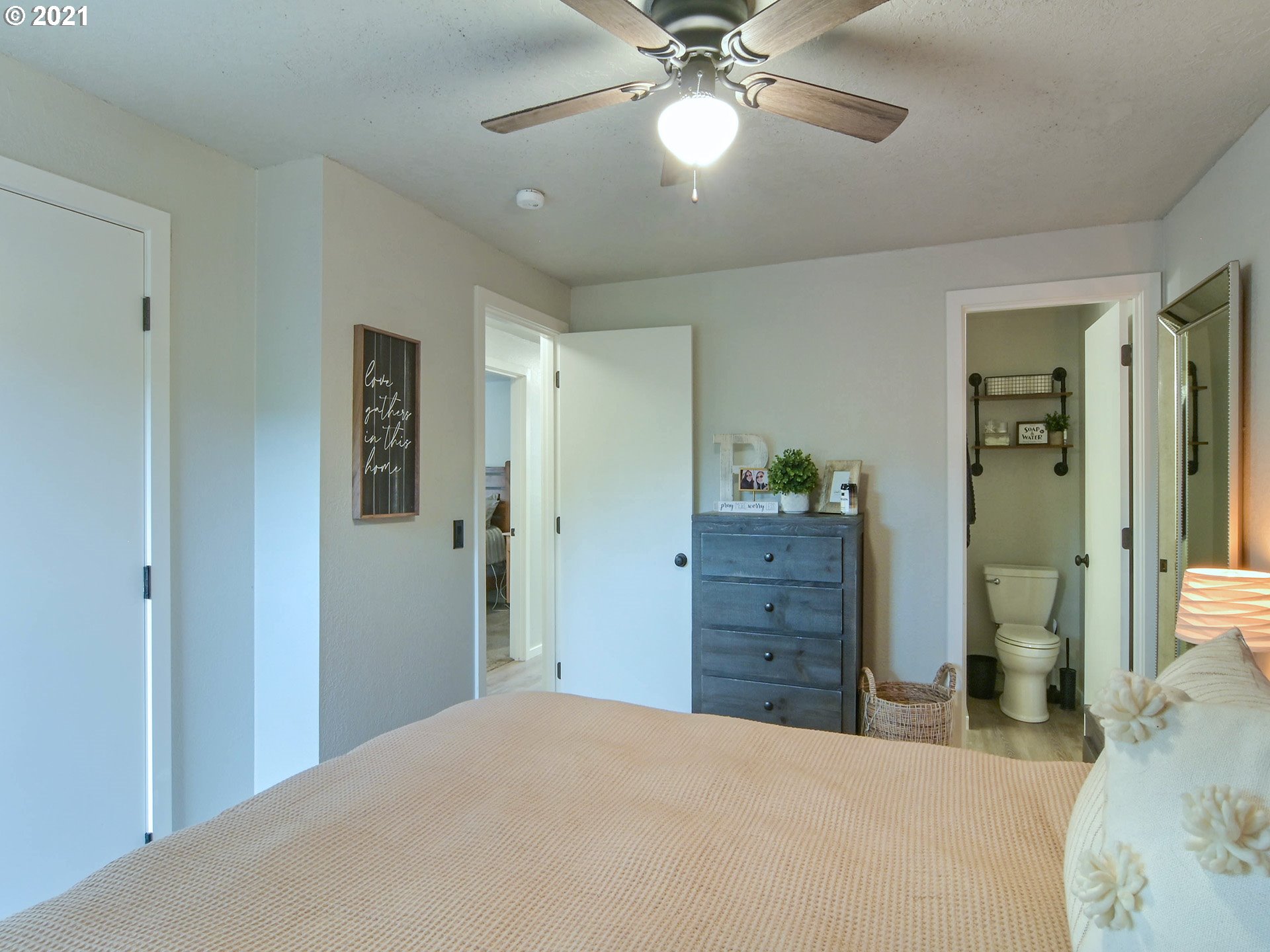7120 B Street Springfield, OR 97478 - Photo 24 of 32 a bedroom with a bed and a chandelier