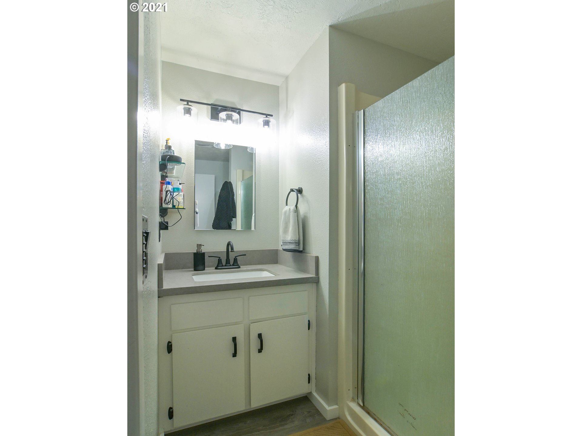 7120 B Street Springfield, OR 97478 - Photo 25 of 32 a bathroom with a double vanity sink and mirror