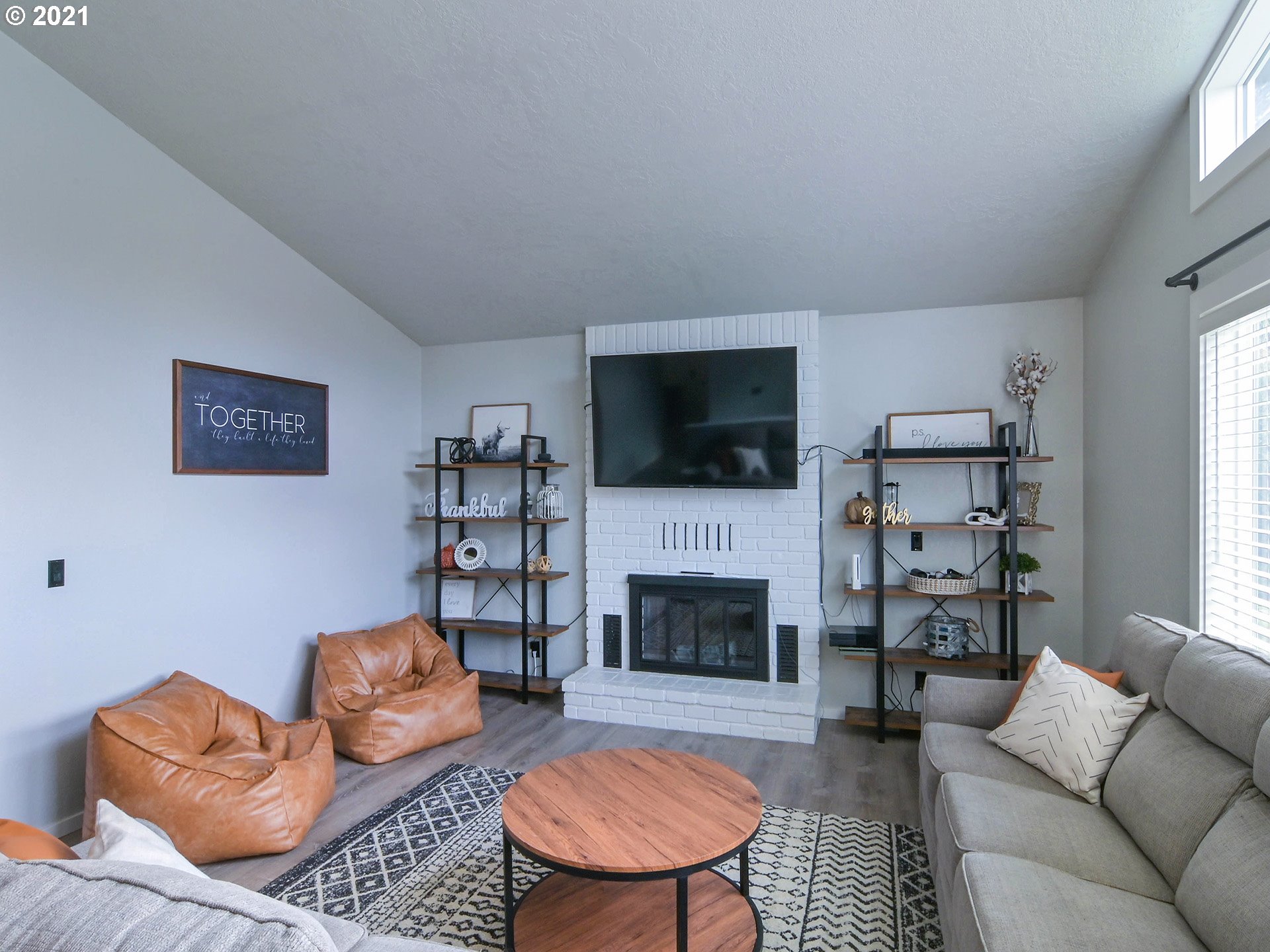 7120 B Street Springfield, OR 97478 - Photo 4 of 32 a living room with furniture flat screen tv and a fireplace