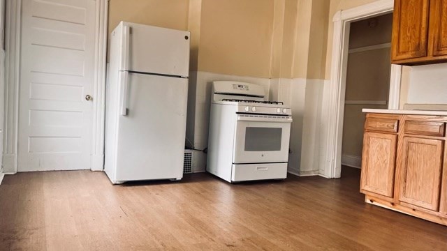 258-260 Orange Street Springfield, MA 01108 - Photo 11 of 16 a view of a kitchen with wooden floor and electronic appliances