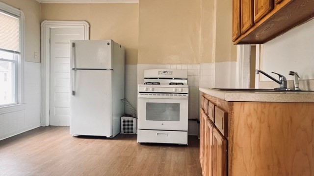 258-260 Orange Street Springfield, MA 01108 - Photo 13 of 16 a kitchen with a refrigerator sink stove and cabinets