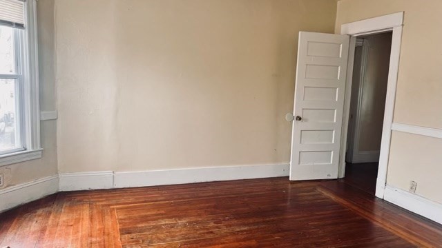 258-260 Orange Street Springfield, MA 01108 - Photo 4 of 16 an empty room with wooden floor and window