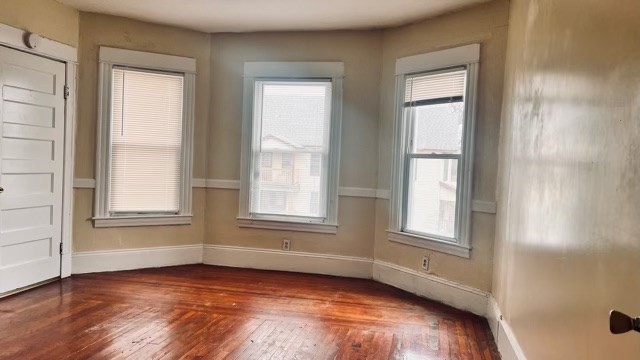 258-260 Orange Street Springfield, MA 01108 - Photo 5 of 16 an empty room with wooden floor and windows