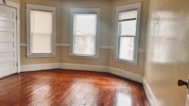 258-260 Orange Street Springfield, MA 01108 - Photo 6 of 16 an empty room with wooden floor and windows