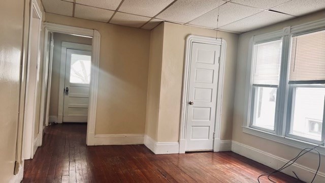 258-260 Orange Street Springfield, MA 01108 - Photo 7 of 16 a view of an empty room with wooden floor and a window