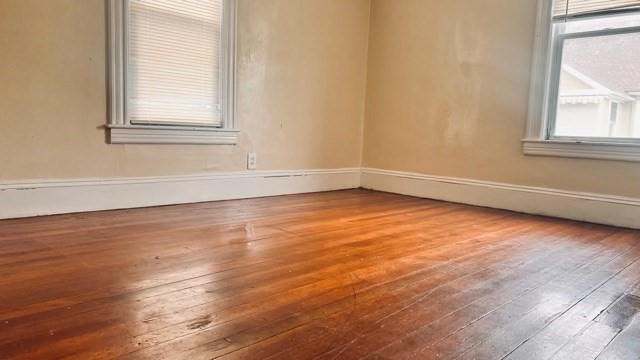 258-260 Orange Street Springfield, MA 01108 - Photo 9 of 16 an empty room with wooden floor and windows