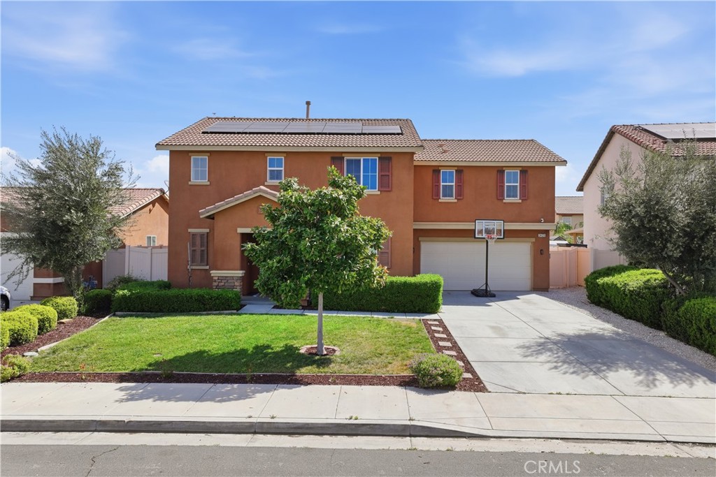3439 Joshua Tree Court Perris, CA 92570 - Photo 1 of 49 a front view of a house with a yard and garage