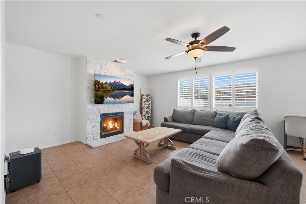 3439 Joshua Tree Court Perris, CA 92570 - Photo 16 of 49 a living room with furniture a fireplace and a window