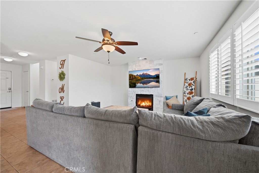3439 Joshua Tree Court Perris, CA 92570 - Photo 17 of 49 a living room with furniture and a flat screen tv