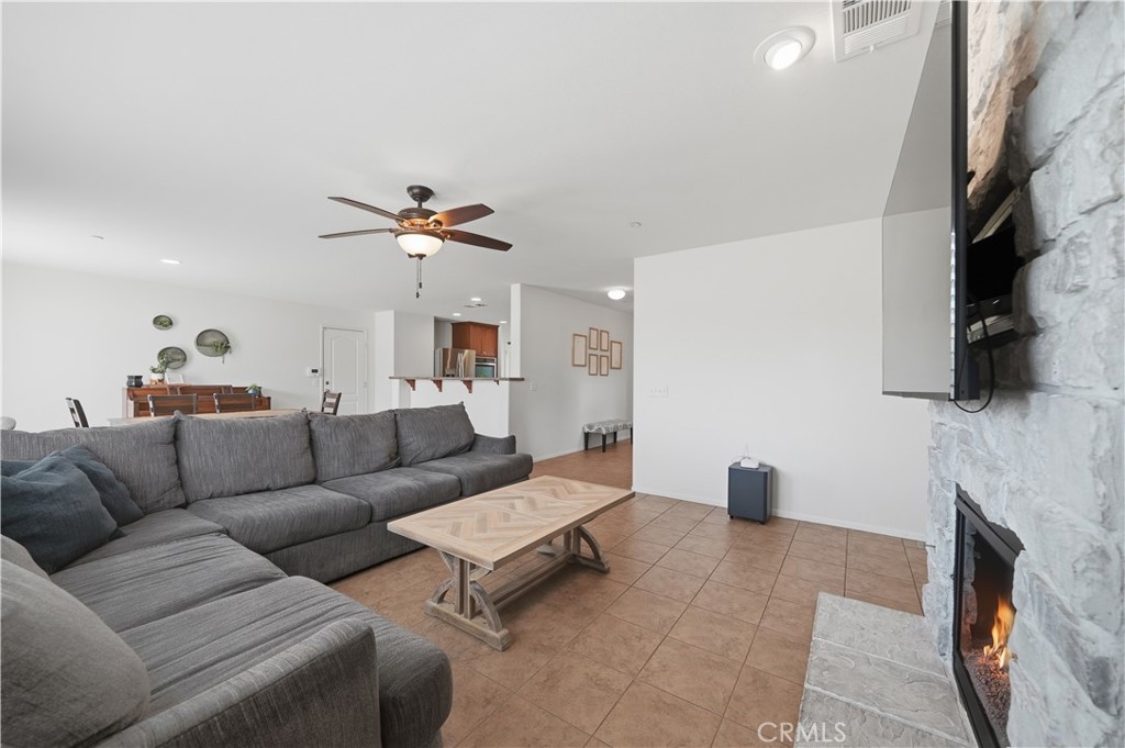 3439 Joshua Tree Court Perris, CA 92570 - Photo 19 of 49 a living room with furniture a fireplace and a flat screen tv