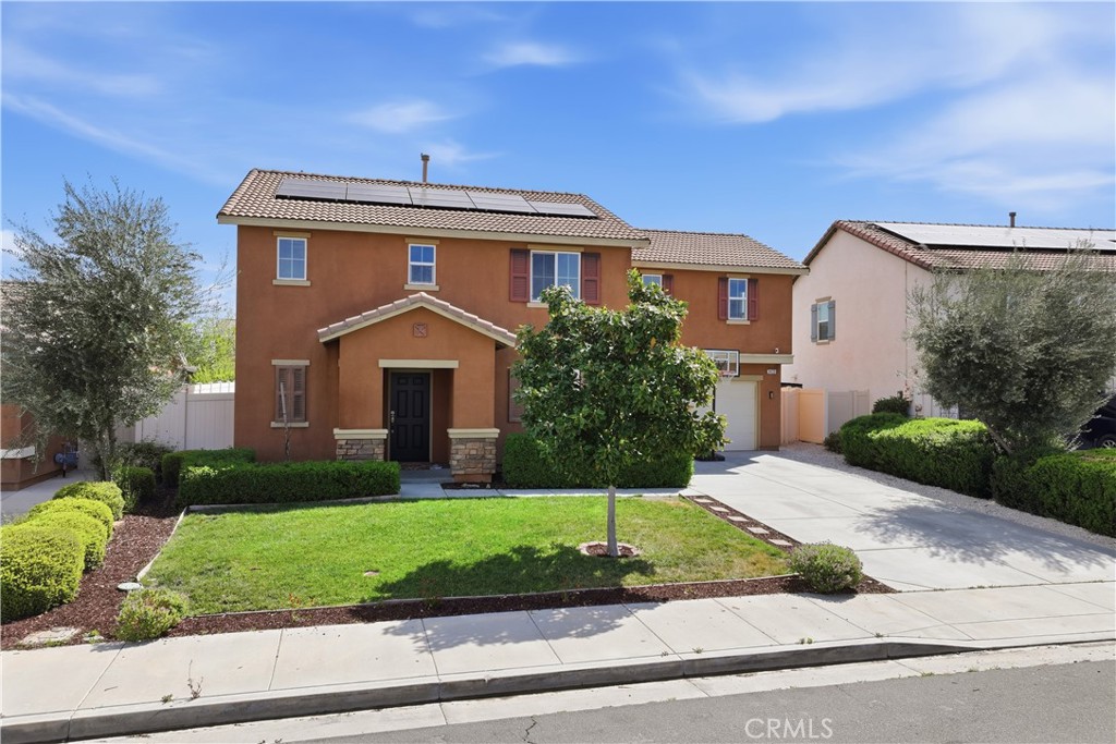 3439 Joshua Tree Court Perris, CA 92570 - Photo 2 of 49 a front view of a house with a yard and garage