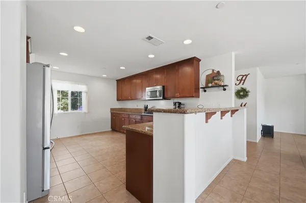 a kitchen with a sink a stove a microwave a counter top space and cabinets